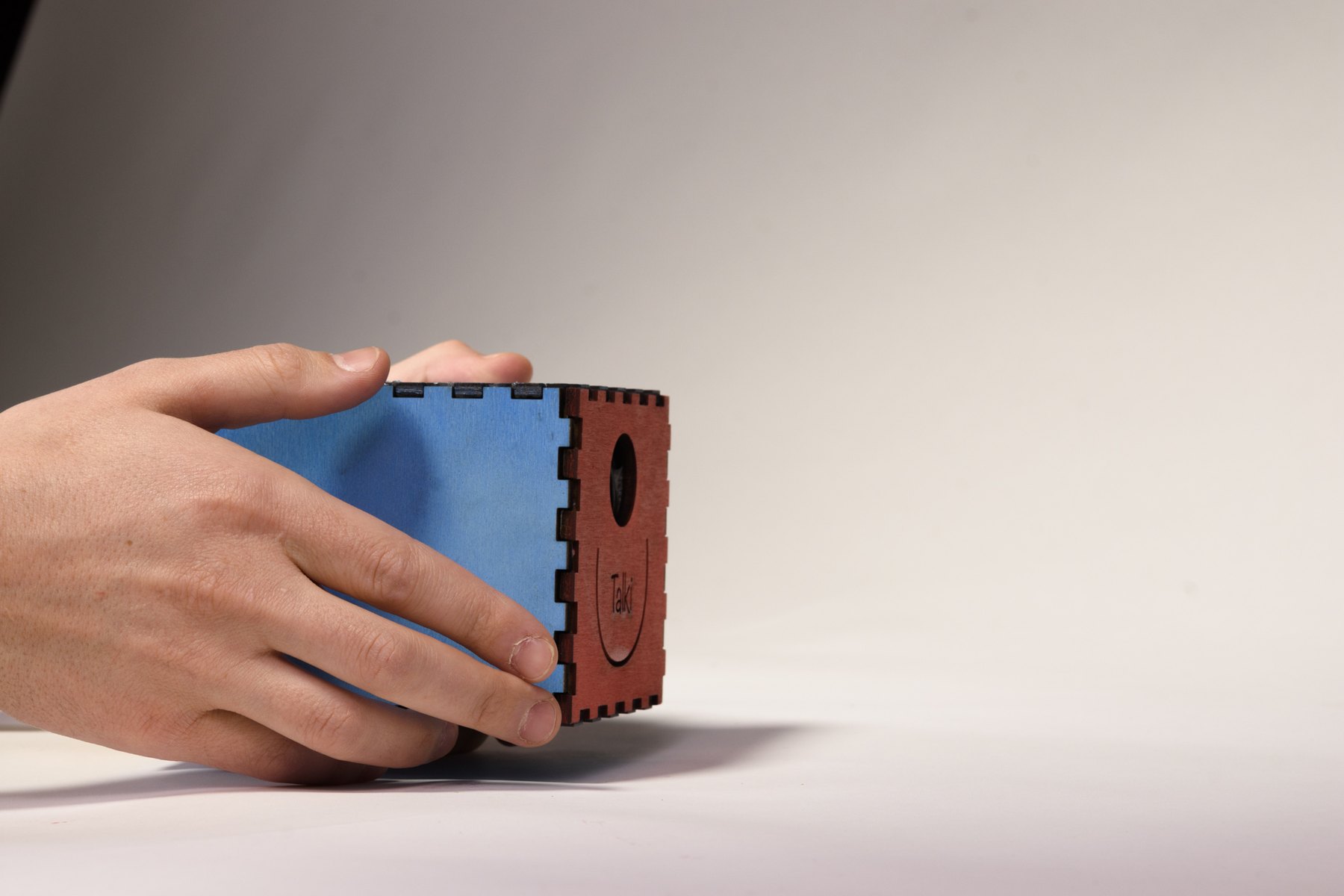 Talki held in one hand, seen from the side